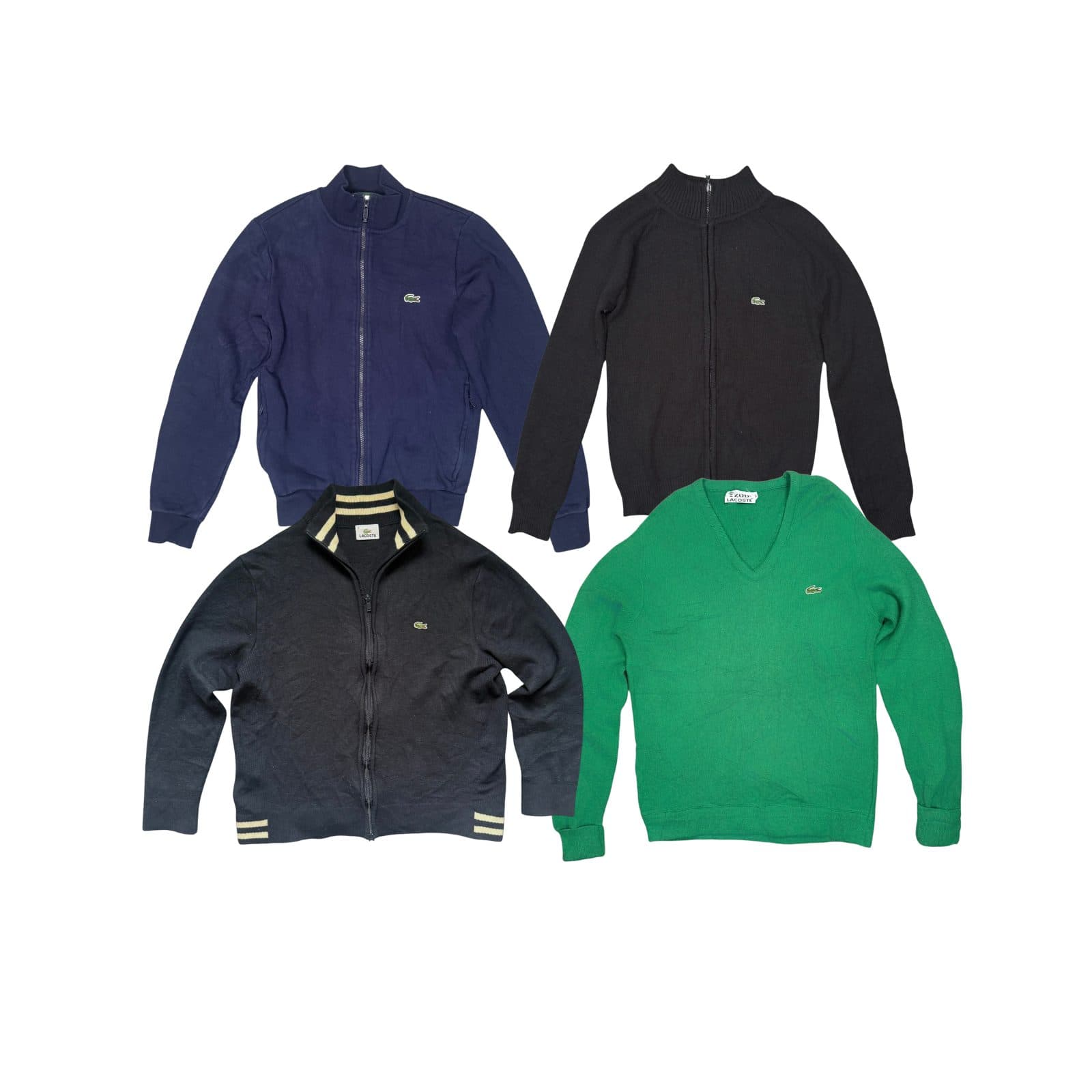 Four Lacoste knits laid flat on white: a navy zip-through cardigan, a black zip cardigan, a black zip knit with cream striped collar and cuffs, and a green v-neck jumper.