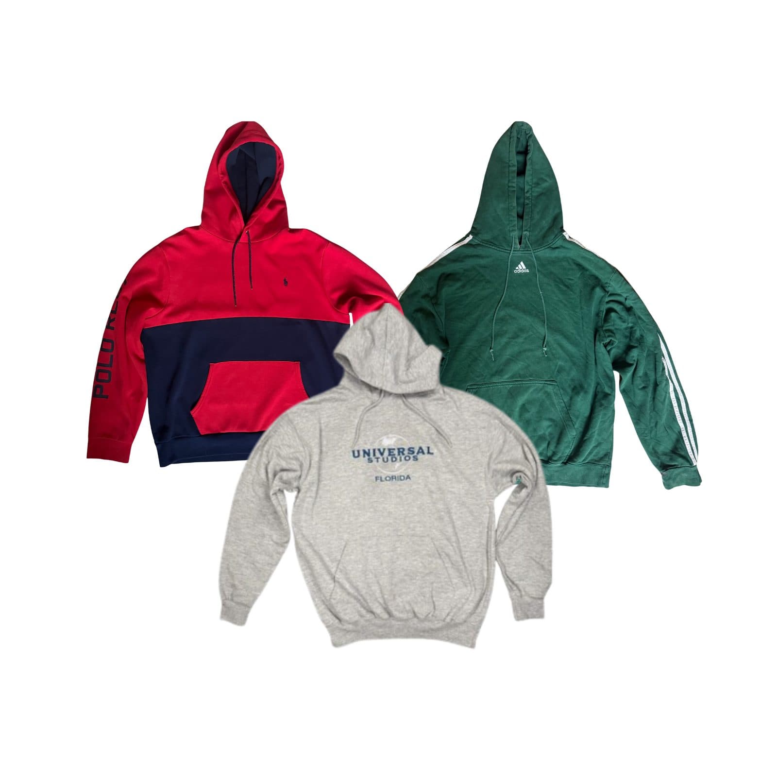 Premium Vintage — Three vintage hoodies laid flat on white: a red and navy Polo Ralph Lauren colour-block hood with sleeve spellout, a green adidas three-stripe hood, and a grey Universal Studios Florida embroidered hood.